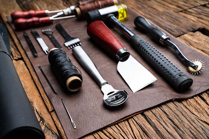 How to Choose Upholstery Products? A Buyer's Guide; Leather Craft Tools On Desk In Tailoring Workshop